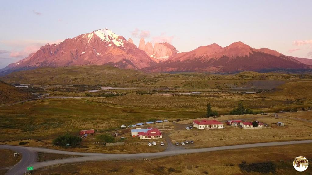 an aerial view of a mountain with houses and a road at Goiien House in Torres del Paine