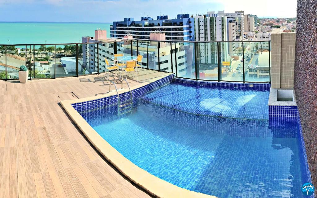 a swimming pool on the roof of a building at Vacanze - Gales de Pajuçara in Maceió