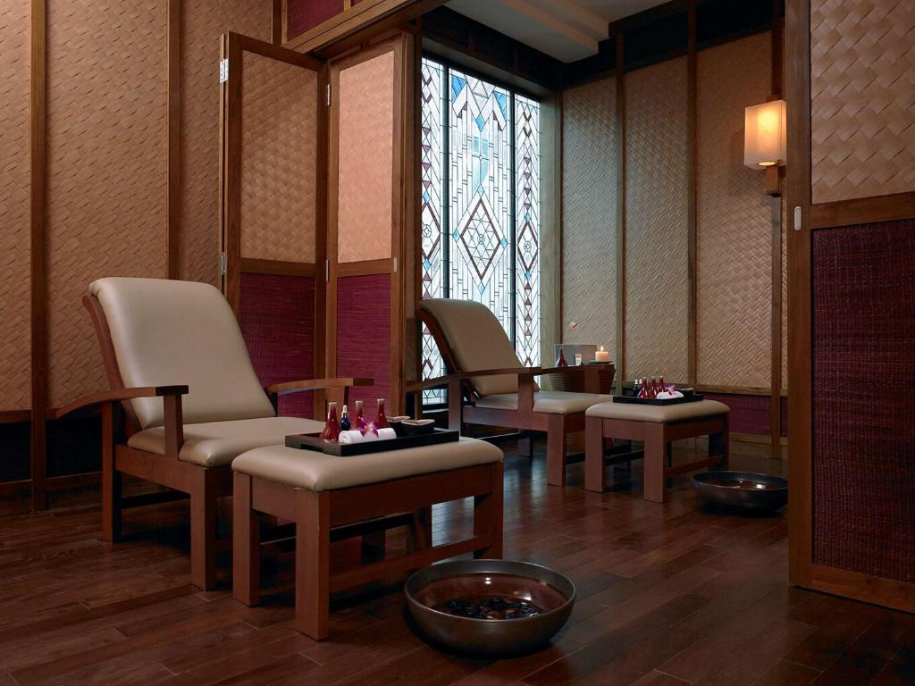 a waiting room with chairs and a stained glass window at Pullman Khon Kaen Raja Orchid in Khon Kaen