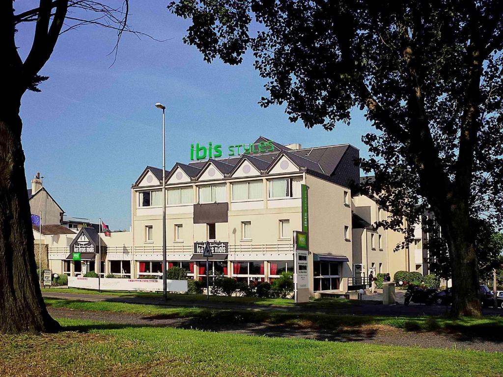 a large white building with a sign on it at ibis Styles Ouistreham in Ouistreham