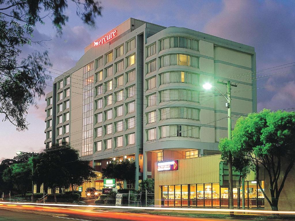 a large building with a clock on the side of it at Mercure Sydney Parramatta in Sydney