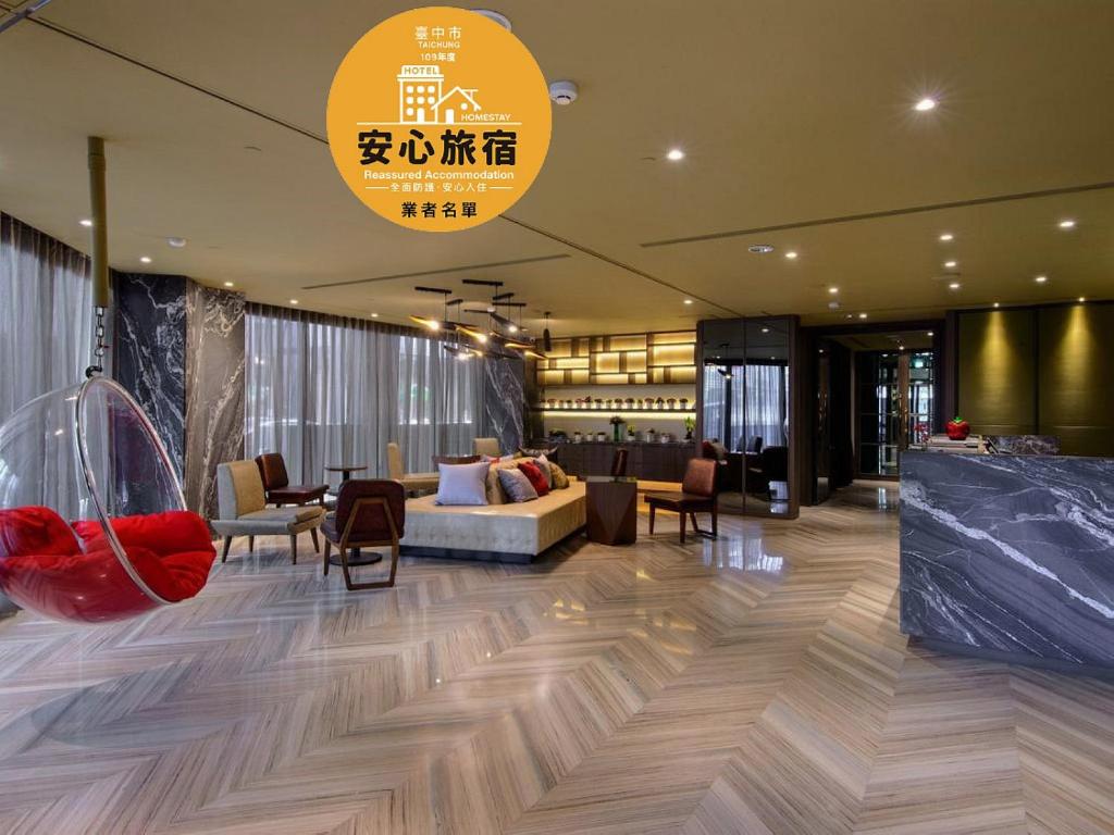 a lobby of a hotel with a couch and chairs at Stay Hotel - Taichung Zhongqing in Taichung