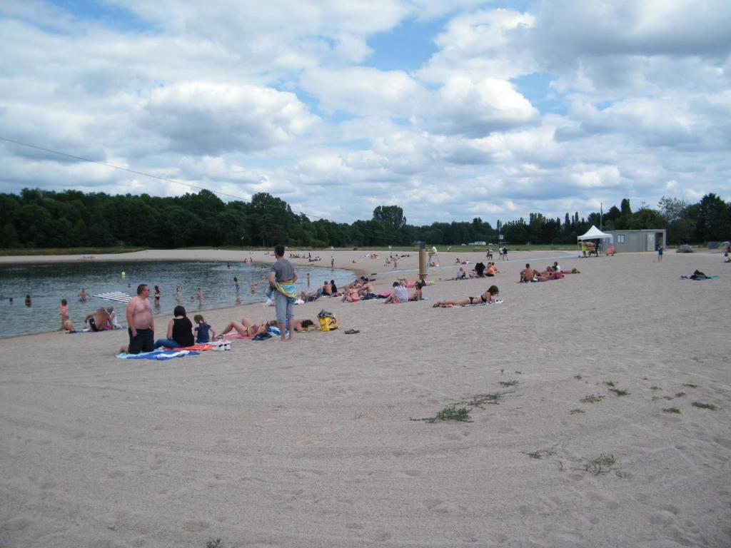 a group of people sitting on a beach at Chez Laurent et Sandrine in Chantraine