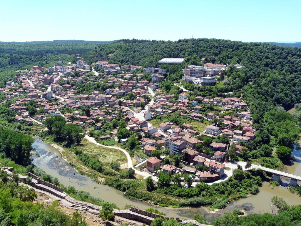 an aerial view of a town next to a river at Day and Night in Veliko Tŭrnovo