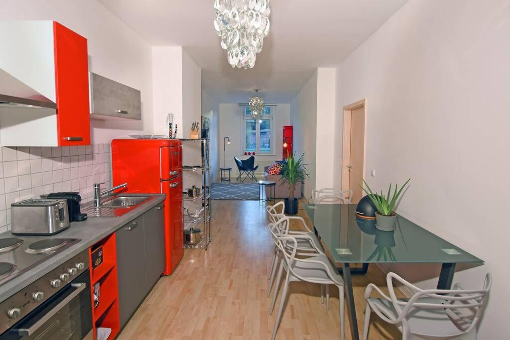 a kitchen with a green table and a red refrigerator at stylish city apartment in Zwickau in Zwickau
