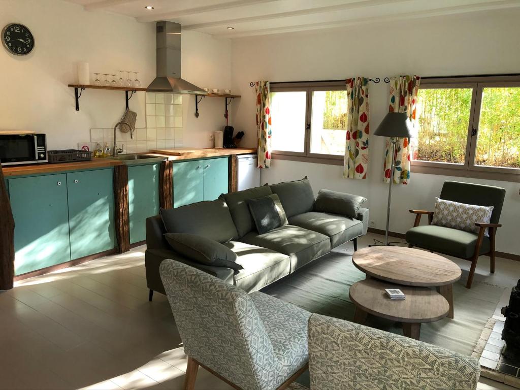 a living room with a couch and a table at B&B Culinaire La Mouline - adults only in Belvèze