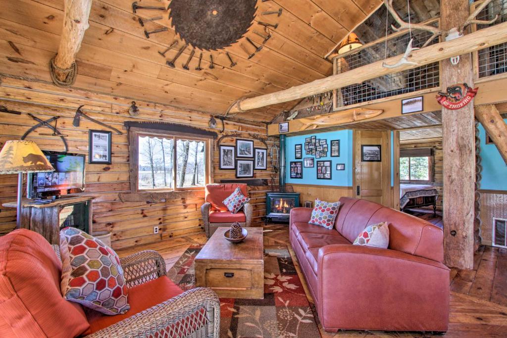 a living room with leather furniture in a log cabin at Cabin on Private Island Less Than 6 Mi to Sand Valley Golf in New Rome