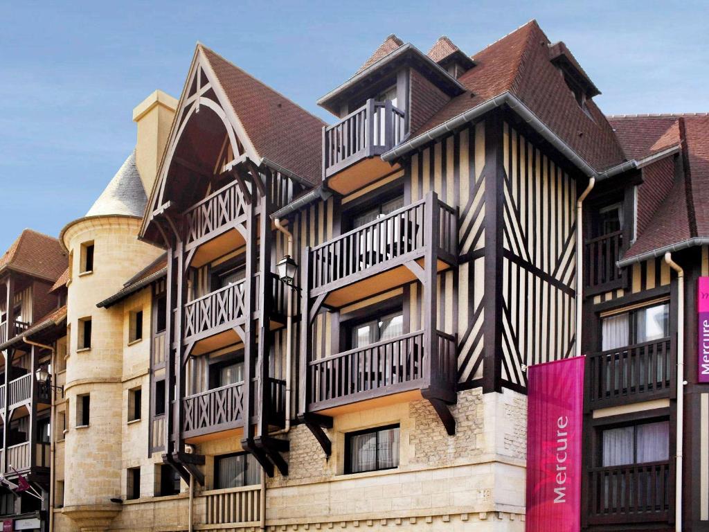 a building with balconies on the side of it at Mercure Deauville Centre in Deauville