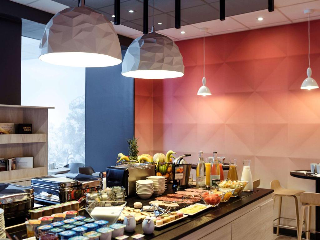 a buffet line in a restaurant with food at Mercure Lyon Centre Beaux-Arts in Lyon