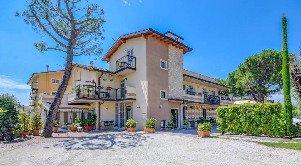 a large house with balconies on a street at Camere America B&B in Sirmione