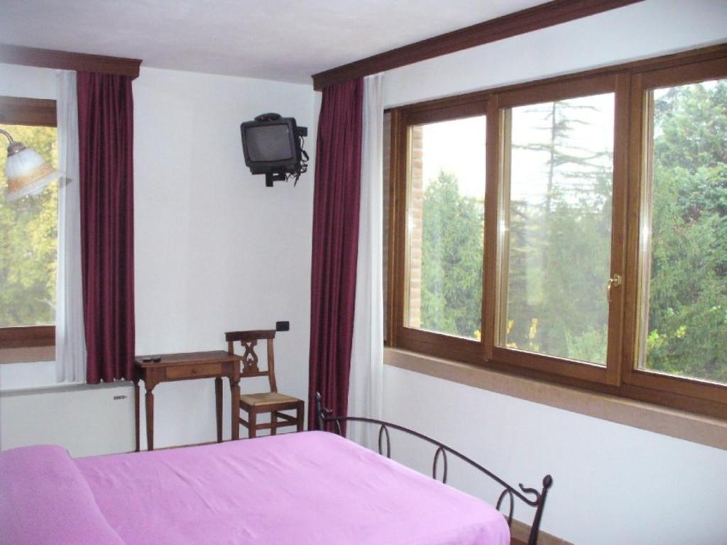 Posteľ alebo postele v izbe v ubytovaní Agriturismo Corte Trincerone