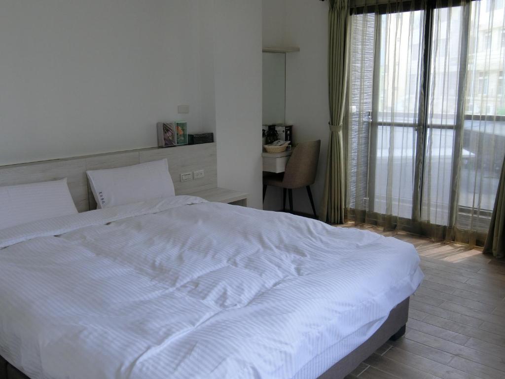 Postel nebo postele na pokoji v ubytování Penghu Summer Aroma Homestay