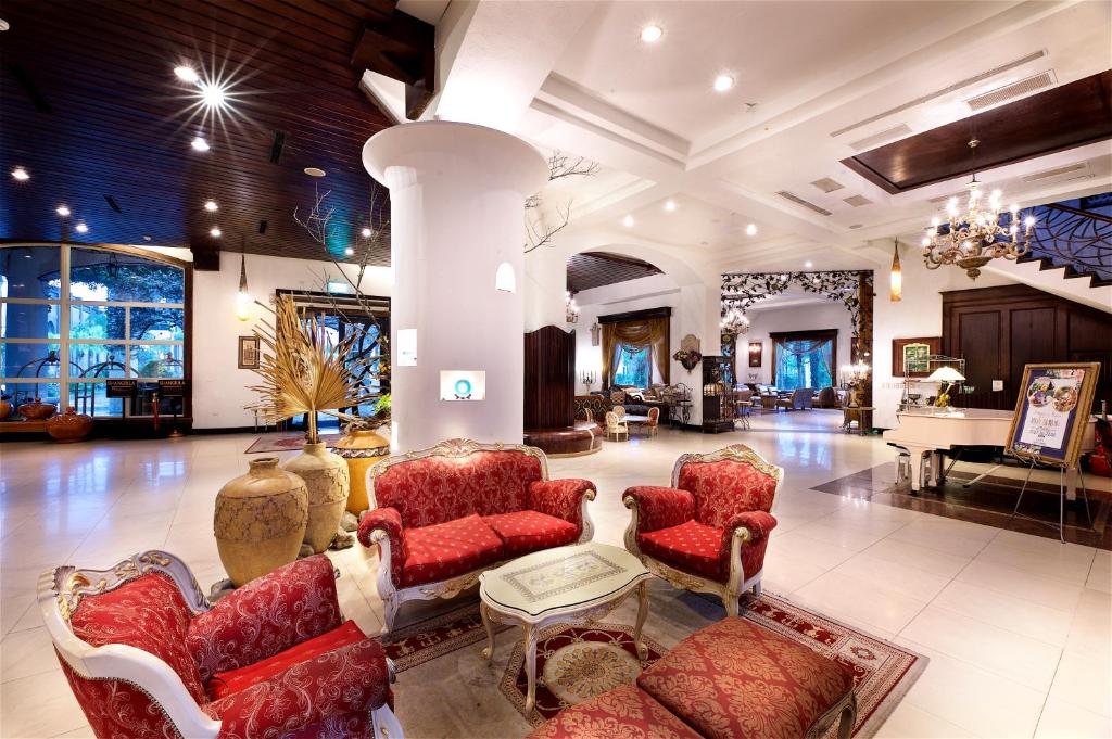 a lobby with chairs and a couch and a piano at Shangrila Boutique Hotel in Wujie