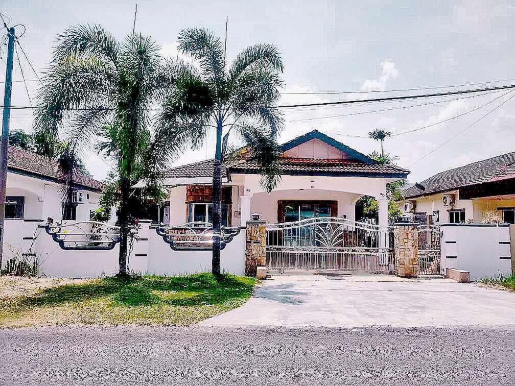 a house with two palm trees in front of it at Taiping Vacation Home in Taiping