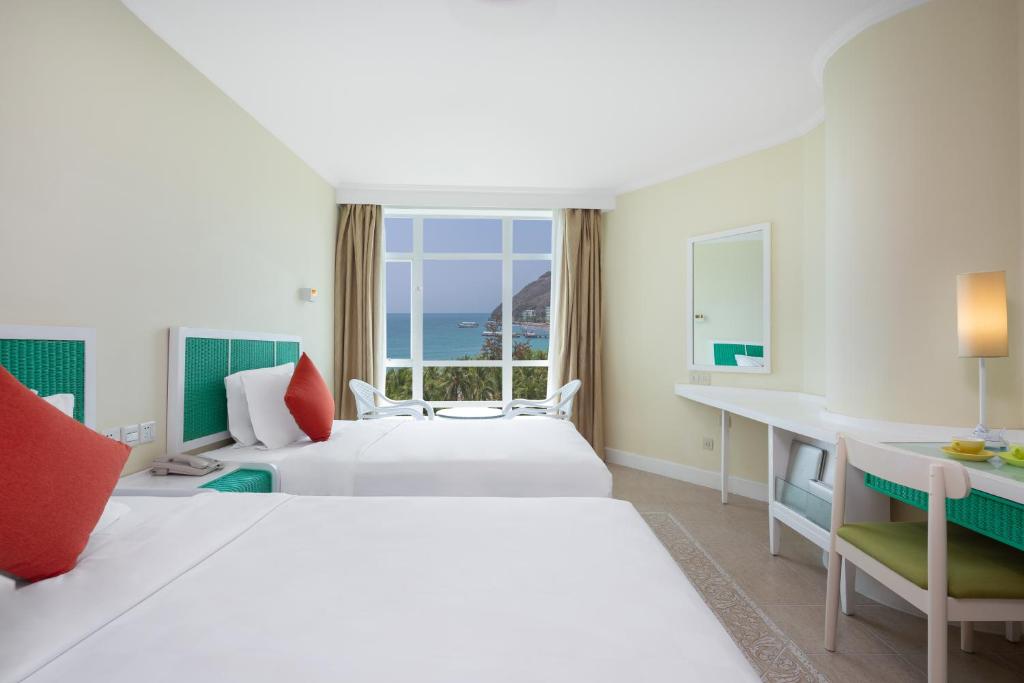 Кровать или кровати в номере Sunshine Resort Intime Sanya