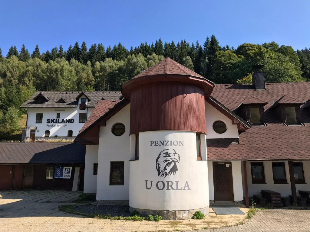 a building with a sign that reads reunion vortex at Penzion U Orla in Petříkov