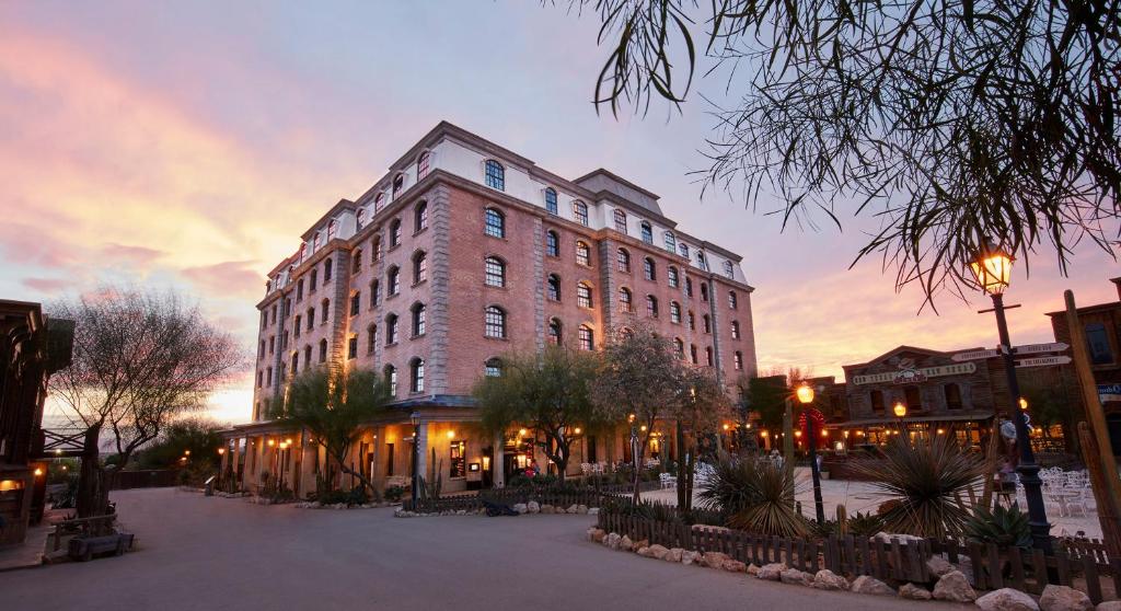 a large building on a city street at dusk at PortAventura Hotel Gold River - Includes PortAventura Park Tickets in Salou