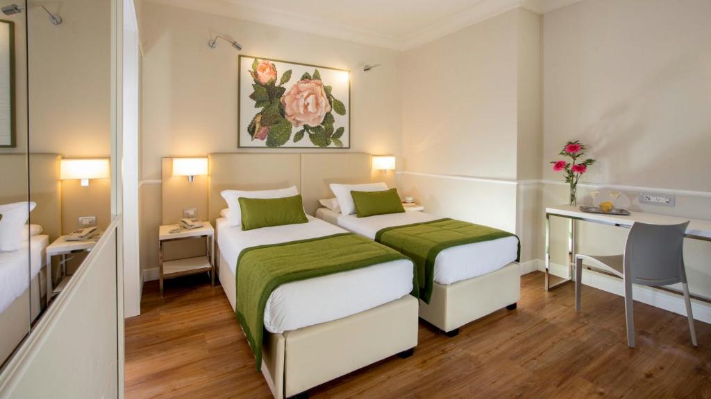 Letto o letti in una camera di Hotel Cristoforo Colombo