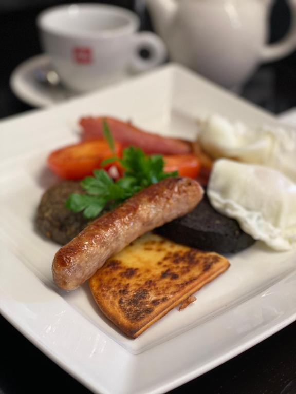 a plate of food with a sausage and toast at No12 Hotel in North Berwick