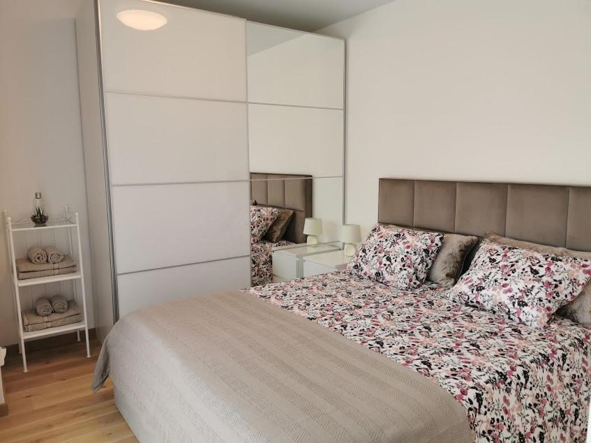 a bedroom with a large bed with pillows on it at Cozy Palanga in Palanga
