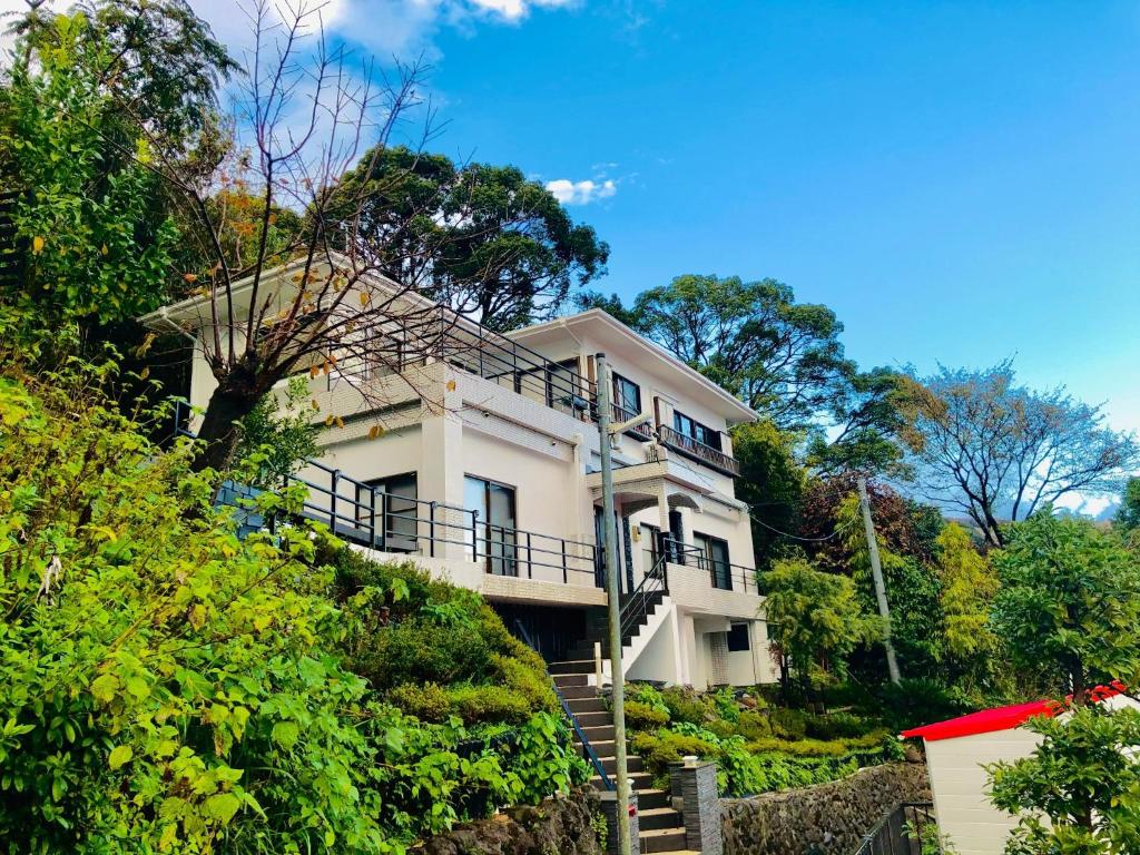 a white house on a hill with stairs in front at Atami - Hotel / Vacation STAY 56914 in Atami