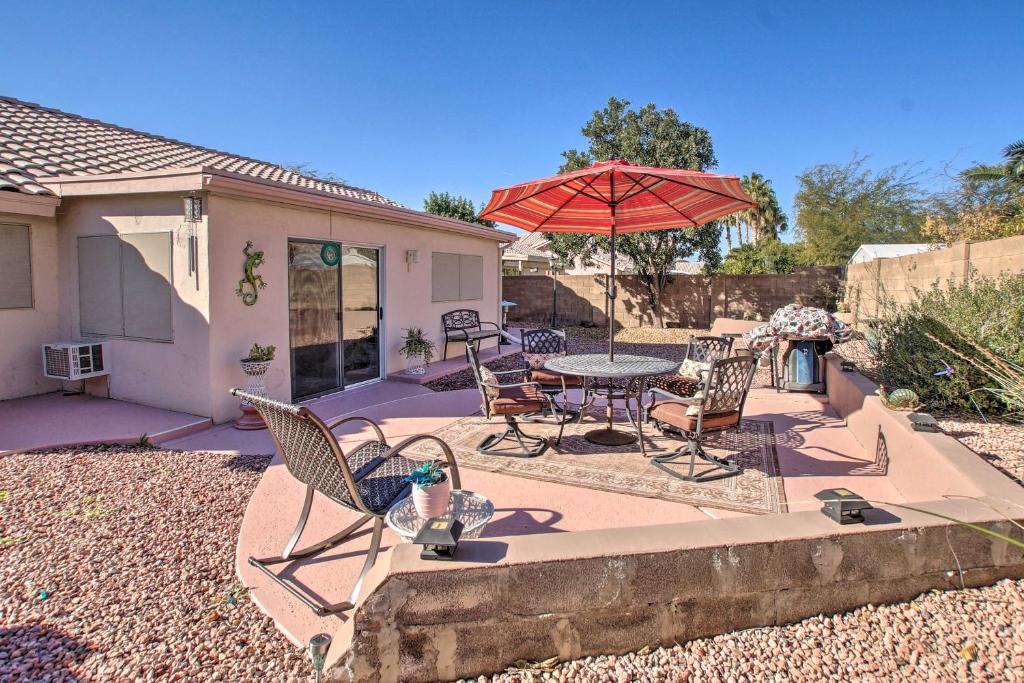 a patio with a table and chairs and an umbrella at Pet-Friendly Central Phoenix Home with Large Patio! in Phoenix