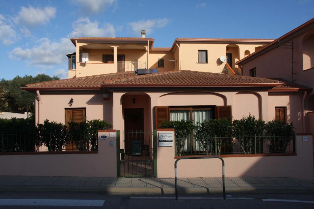 uma casa com um portão em frente em L'Alloggio-Not just rooms em Olbia