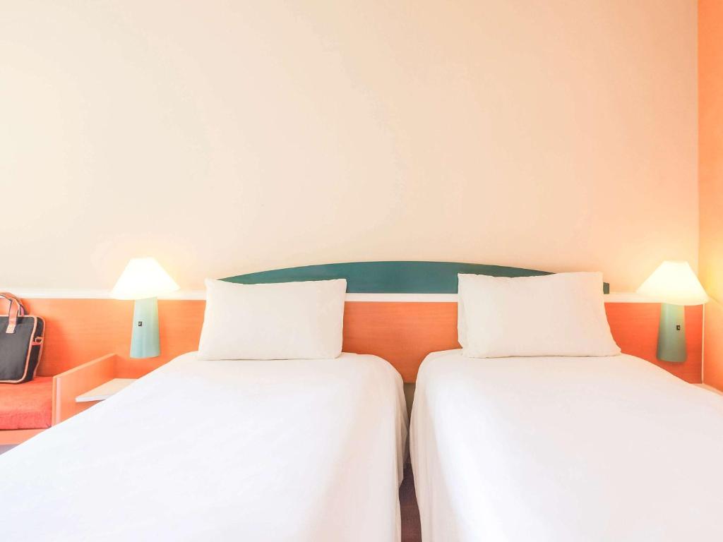 Postel nebo postele na pokoji v ubytování Ibis Guadalajara Expo