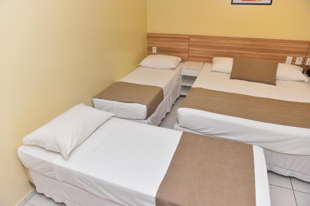 Postel nebo postele na pokoji v ubytování Hotel Três Caravelas