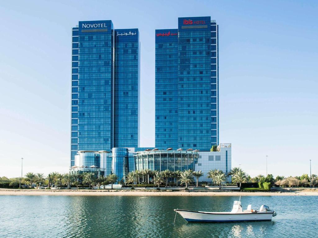 فندق نوفوتيل أبو ظبي غايت في أبوظبي: قارب في الماء امام المدينة