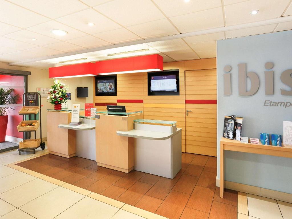 a boston pharmacy lobby with two counters and a sign at ibis Etampes in Étampes