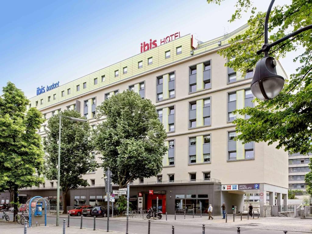 a large building with a clock on the side of it at ibis budget Berlin Kurfürstendamm in Berlin