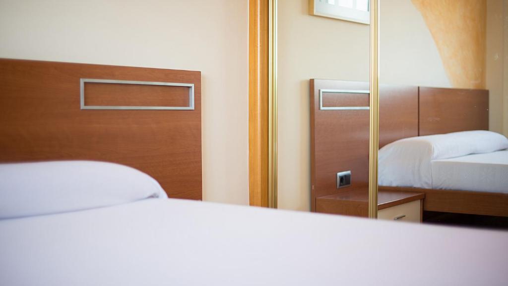Postel nebo postele na pokoji v ubytování R34 Ático RAMBLA
