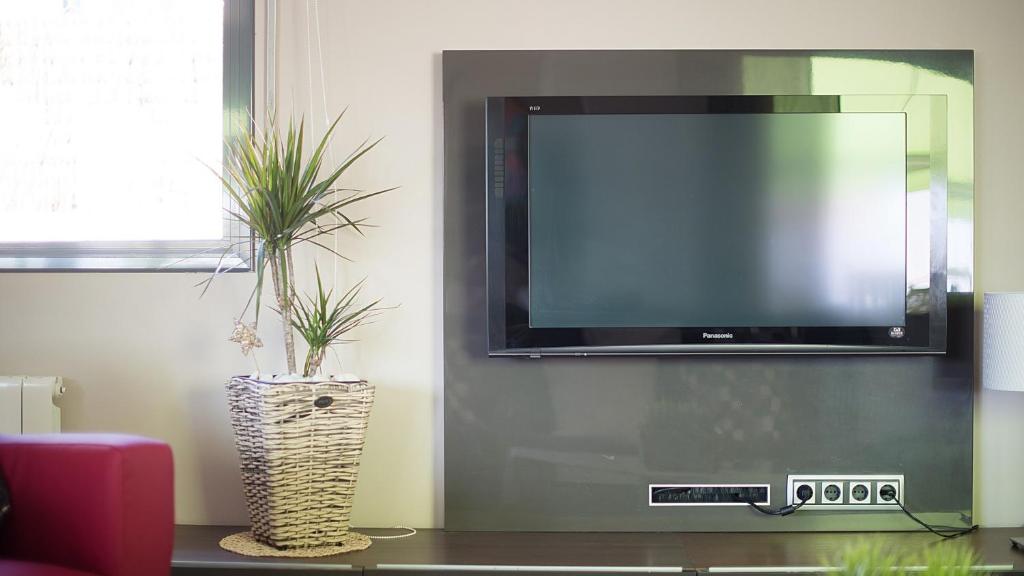 Televízia a/alebo spoločenská miestnosť v ubytovaní R64 Deluxe Villa Déjà Vu