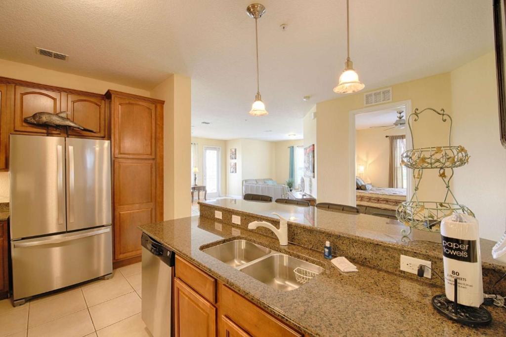 a kitchen with a sink and a stainless steel refrigerator at 5048 Viz Cay in Orlando