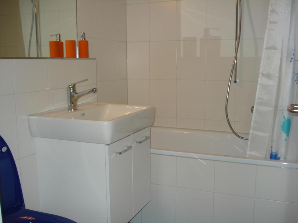 a white bathroom with a sink and a shower at Chalet Viola in Wengen