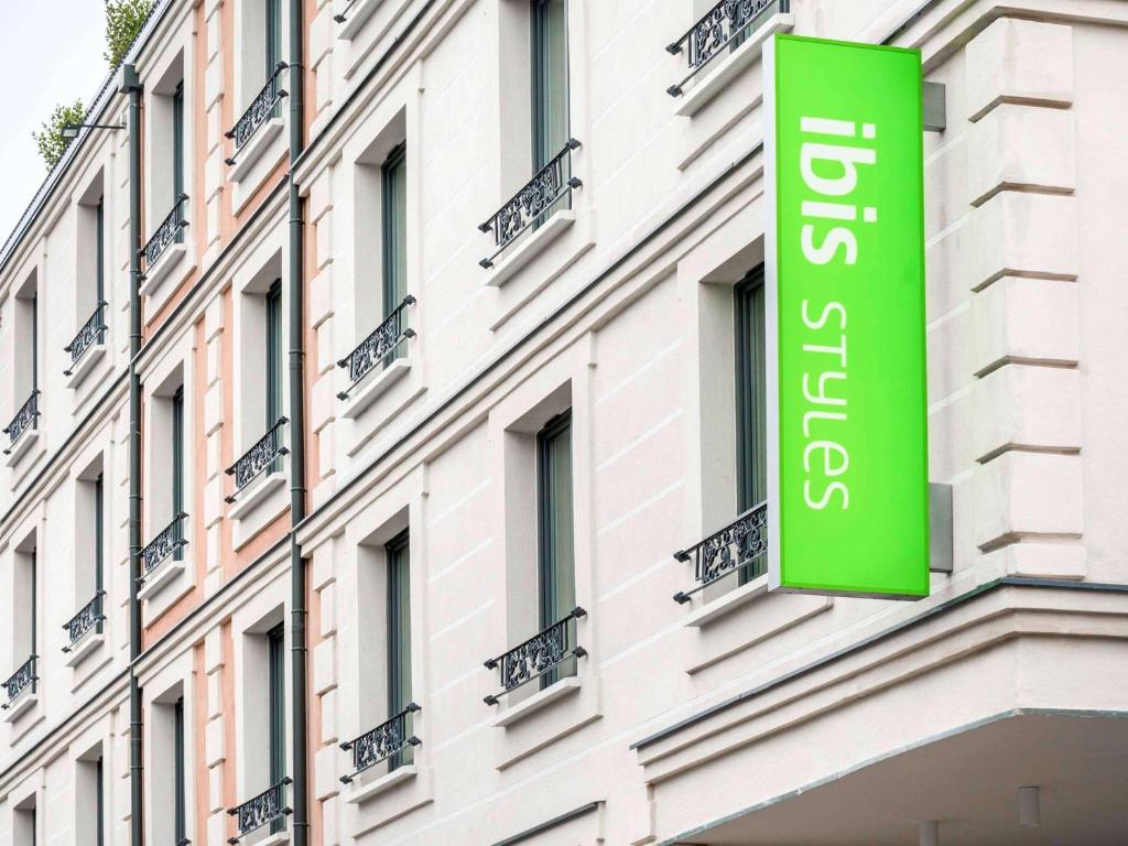 ein grünes Schild an der Seite eines Gebäudes in der Unterkunft ibis Styles Clamart Gare Grand Paris in Clamart