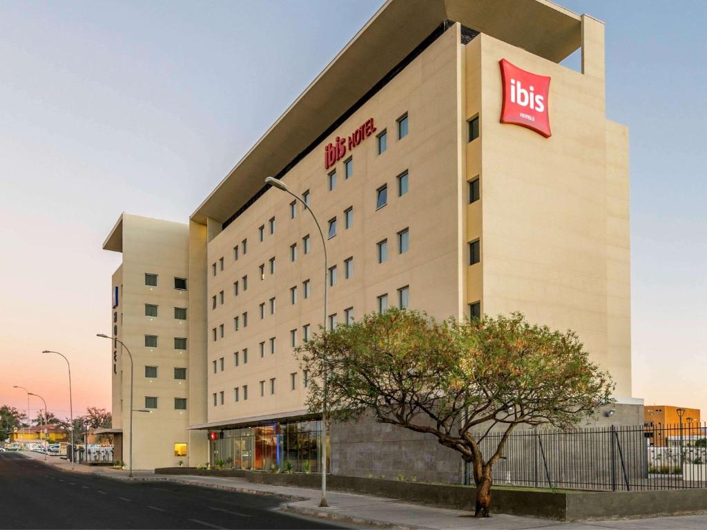 a building with a big sign on the side of it at ibis Calama in Calama