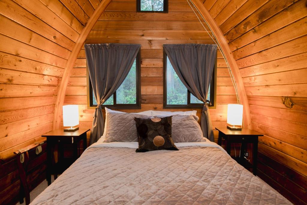 a bedroom with a bed in a wooden cabin at Backeddy Resort and Marina in Egmont