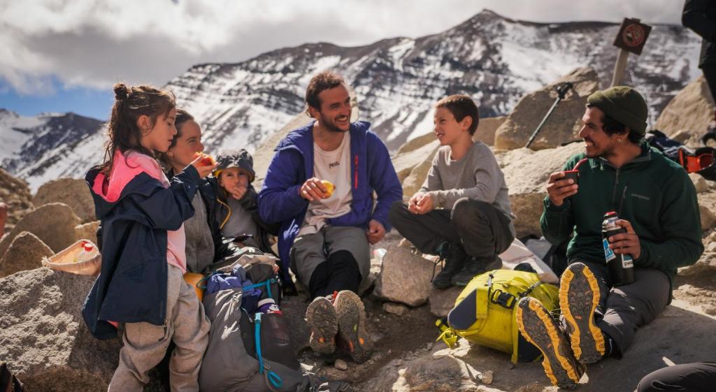 a group of people sitting on top of a mountain at Río Serrano Hotel + Spa in Torres del Paine