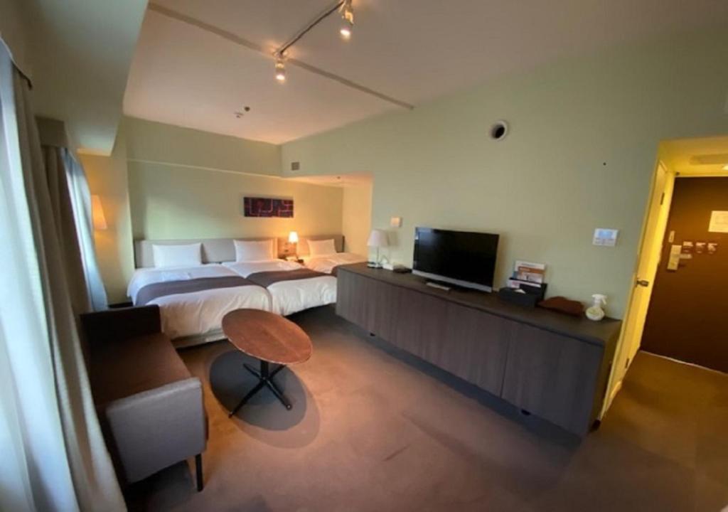 TV a/nebo společenská místnost v ubytování Ginza Grand Hotel