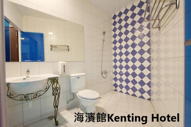 a bathroom with a toilet and a sink at Kenting Hostel in Kenting