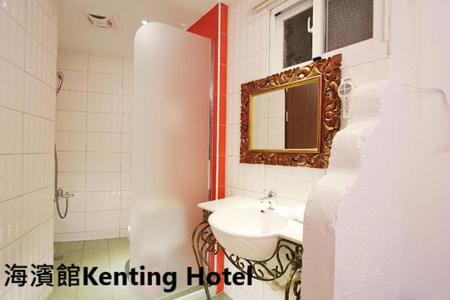 a bathroom with a sink and a mirror at Kenting Hostel in Kenting