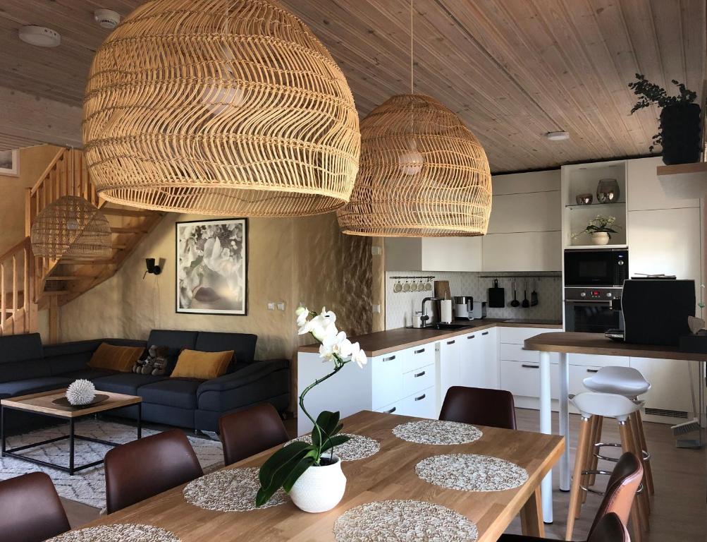 a kitchen and a living room with a table and chairs at Väike-Mere Villa in Haapsalu
