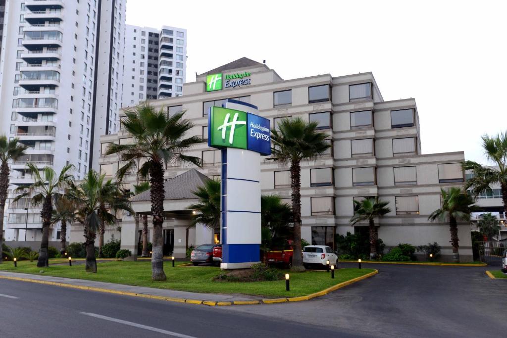 a hotel with a sign in front of a building at Holiday Inn Express - Iquique, an IHG Hotel in Iquique