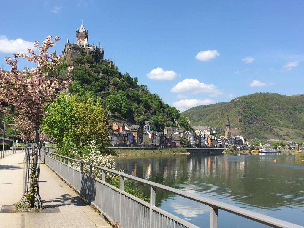 a view of a river with a town on a hill at Ferienhaus Maja in Cochem