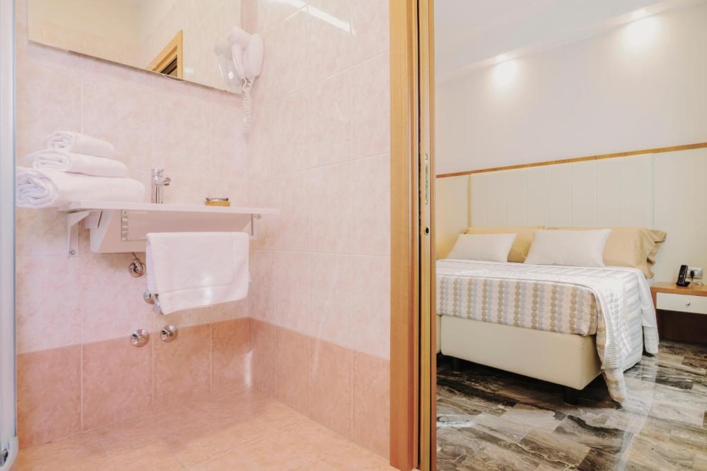 Łóżko lub łóżka w pokoju w obiekcie Piccolo Hotel