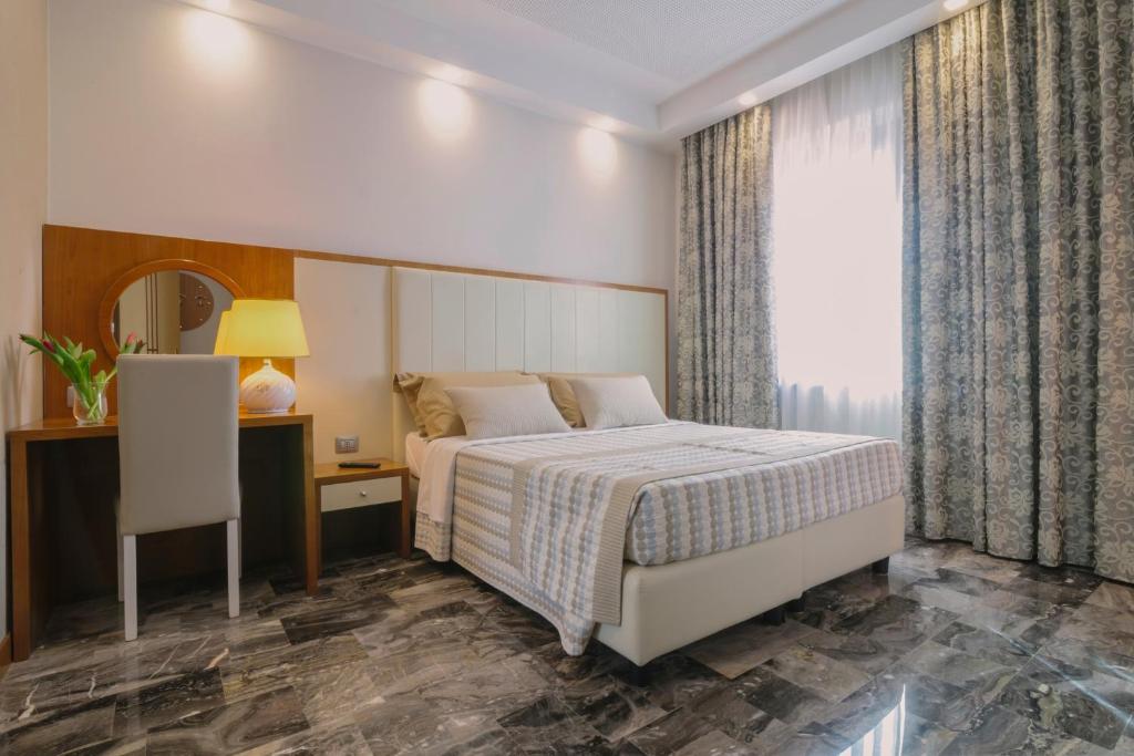 Łóżko lub łóżka w pokoju w obiekcie Piccolo Hotel