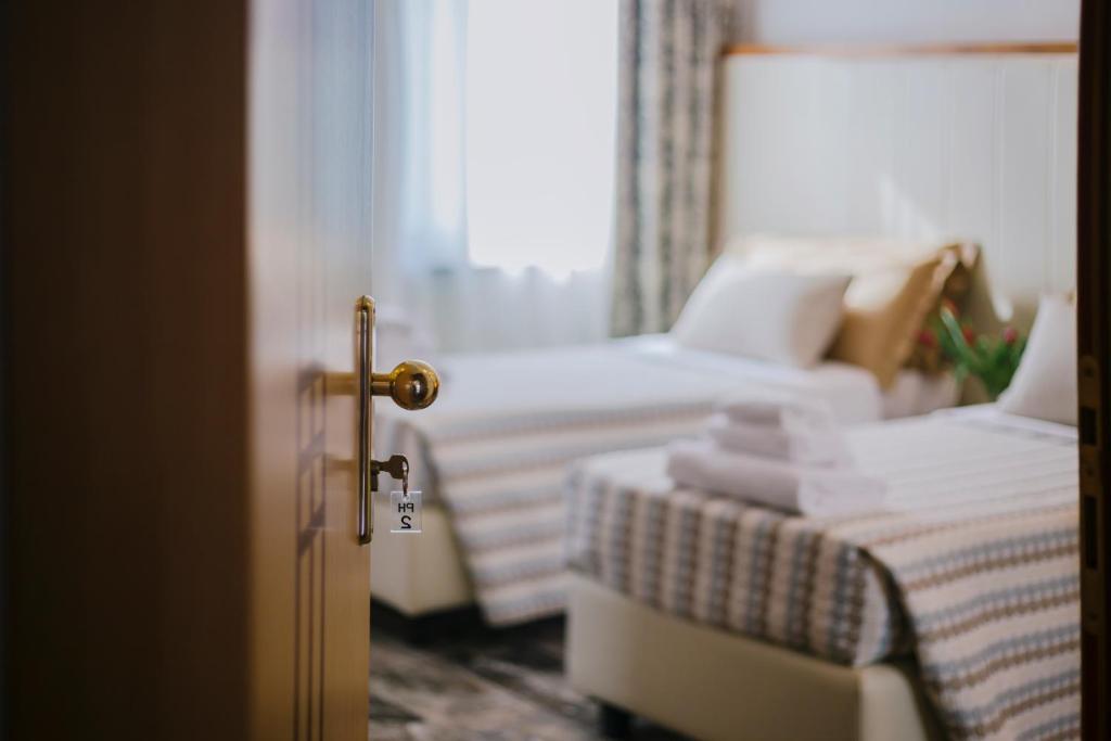 Łóżko lub łóżka w pokoju w obiekcie Piccolo Hotel