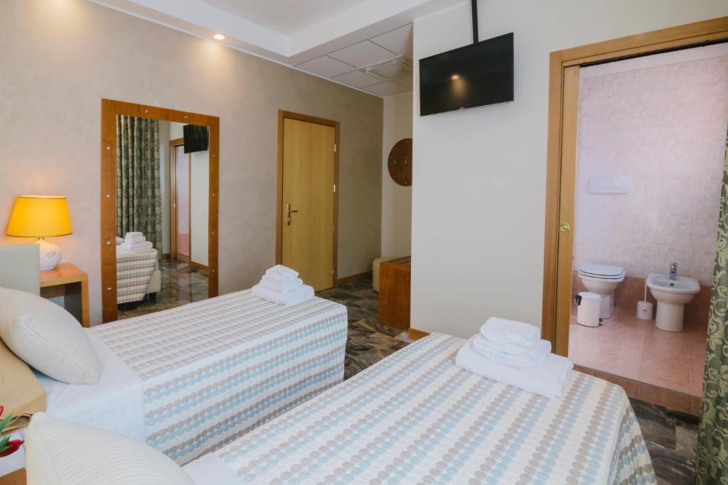 Łóżko lub łóżka w pokoju w obiekcie Piccolo Hotel